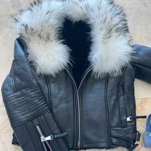 Black leather moto jacket with white fur collar